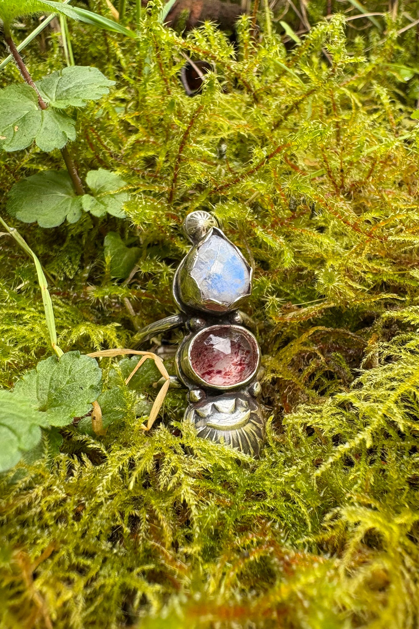 Handmade sterling silver ring with moonstone and strawberry quartz in a bed of moss