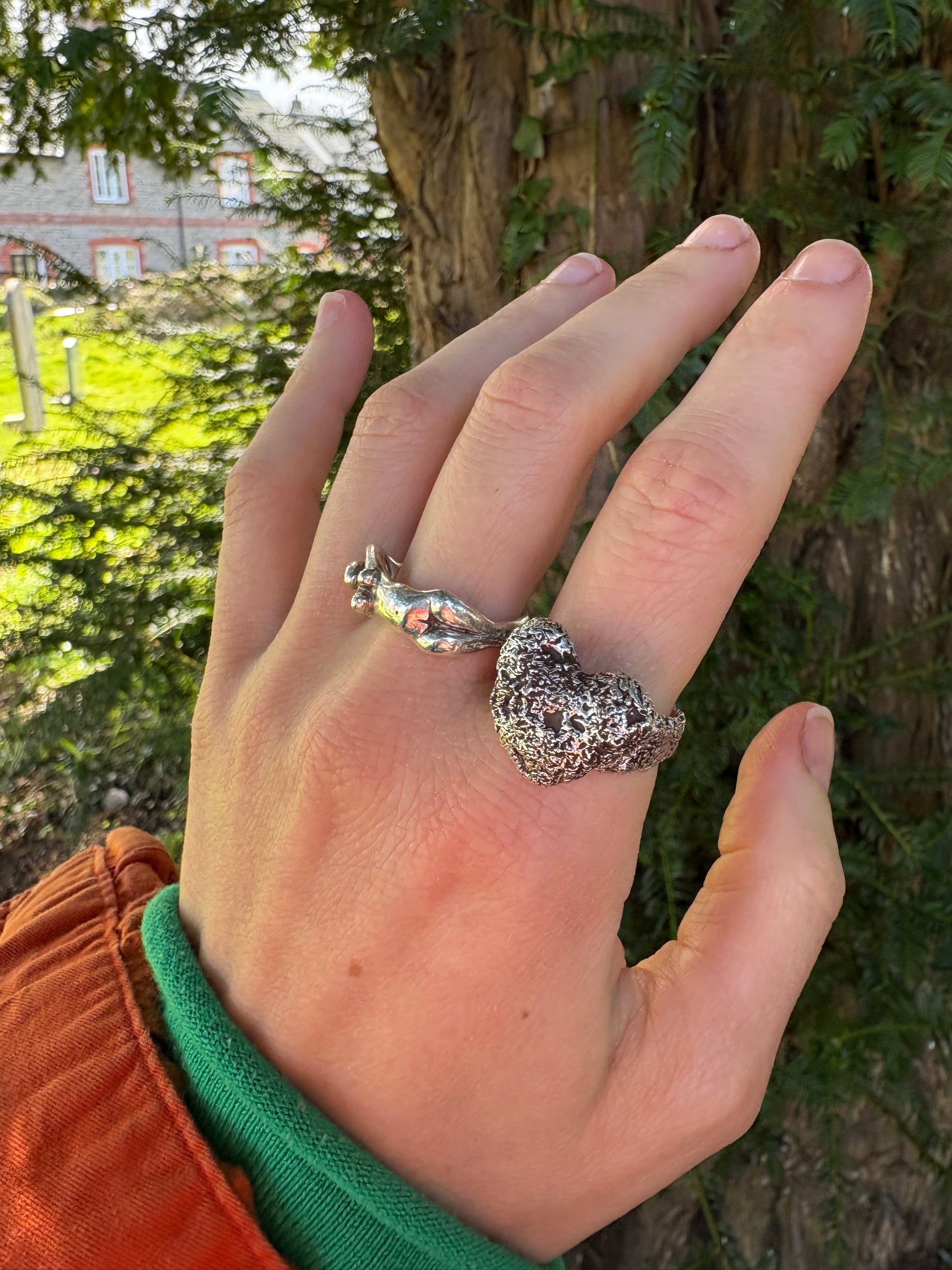 hand wearing sterling silver chunky heart shaped ring, large statement heavy ring